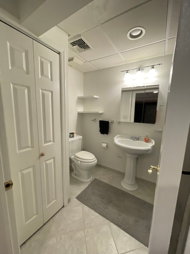 The bathroom has a storage area as well as shelves. (Bathroom 1/2) - 18 Old Neck Ct