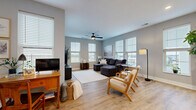 Located at 5920 Market St in Lewis Center, OH, this single-floor residence offers a thoughtfully designed open-concept layout that seamlessly integrates the living room, dining room, and kitchen into one bright, welcoming space. Light hardwood flooring runs throughout, complementing the soft gray walls and white trim for a clean, contemporary aesthetic.

The kitchen is well-equipped with white shaker cabinetry, stainless steel appliances, a white subway tile backsplash, and ample counter space. A peninsula with pendant lighting connects the kitchen to the dining and living areas, enhancing the open flow. The living room features multiple large windows with views of the surrounding area, a ceiling fan, and generous room for seating.

The bedroom is a comfortable retreat with ceiling fan, multiple windows with natural light, and easy access to two closets. The bathroom is finished with white cabinetry, a dual-sink vanity, black hardware accents, and a tiled walk-in shower with a sleek glass door. Additional spaces include a hallway, a dedicated laundry area, a private patio, and an entrance foyer. The overall ambiance is modern, bright, and functional.