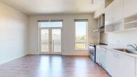 Located at 1720 R St in Sacramento's vibrant Midtown district, this studio apartment offers a thoughtfully designed single-floor layout that maximizes every inch of its compact footprint. The open living area is bathed in natural light, courtesy of large windows and a set of French doors that open onto a private balcony, offering pleasant views of surrounding greenery. Warm wood-style flooring runs throughout the space, complementing the clean, white walls and creating a bright, modern aesthetic. A wall-mounted mini-split unit provides efficient climate control. The open kitchen is well-appointed with white cabinetry, ample upper and lower storage, a stainless steel range with a sleek overhead hood, a dishwasher, and a full-size refrigerator — all seamlessly integrated into the living space. A hallway connects the main living area to the bedroom space, which features louvered closet doors for storage. The bathroom is clean and functional, finished with wood-style flooring and includes a full bathtub and shower combination, a vanity with storage, and a toilet. Track lighting throughout adds a contemporary touch. This studio presents a streamlined, move-in-ready living environment in one of Sacramento's most walkable neighborhoods.