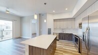 Located at 401 SE Central Pkwy in Stuart, FL, this modern 3-bedroom, 2-bathroom residence offers a thoughtfully designed open-concept layout with contemporary finishes throughout. Light wood-style flooring flows seamlessly across all living areas, creating a bright and cohesive aesthetic.

The kitchen is a standout feature, showcasing a large center island with a quartz countertop, two-tone cabinetry pairing light upper cabinets with dark wood lower cabinets, a marble-style tile backsplash, and stainless steel appliances including a dishwasher, range, and microwave. Pendant lighting above the island adds a stylish finishing touch.

The living room is bright and open, connecting naturally to the kitchen for an ideal entertaining layout. The primary bedroom is generously sized, featuring sliding glass doors that open to a private balcony with outdoor views and abundant natural light. Additional bedrooms are well-proportioned with large windows that bring in natural light, and a walk-in closet provides excellent storage.

The bathrooms are finished to a high standard. One features a dual-sink vanity with walnut-toned cabinetry and a glass-enclosed shower, while the other includes a full soaking tub with glossy subway tile surround. Clean white walls and tile flooring complete the polished, modern look throughout.