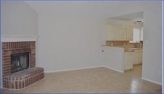 This inviting living room features a charming brick fireplace, perfect for cozy gatherings. - 3108 Silent Creek Trl