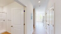 Located at 200 Garden St, this single-floor unit offers a thoughtfully designed layout that makes efficient use of its space. Light wood-tone flooring runs throughout, creating a warm and cohesive aesthetic across every room.

The kitchen is outfitted with white shaker-style cabinetry, light stone countertops, and a full suite of stainless steel appliances including a refrigerator, electric range, built-in microwave, and dishwasher. A window beside the kitchen brings in natural light, enhancing the clean, modern feel of the space.

The main living area is bright and open, with a wall of large double-hung windows that frame expansive views of surrounding greenery and open sky. A wall-mounted ductless mini-split unit provides efficient climate control, while a baseboard heater offers additional warmth. Recessed lighting and crisp white walls keep the space feeling fresh and airy.

The bathroom is finished with the same light wood flooring and features a walk-in shower with a sleek sliding glass door, a white vanity, and clean white walls. Recessed lighting and a grab bar add both practicality and polish to the room.

Overall, this unit presents a clean, modern interior with natural light, outdoor views, and functional finishes throughout.