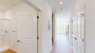 Located at 200 Garden St, this single-floor unit offers a thoughtfully designed layout that makes efficient use of its space. Light wood-tone flooring runs throughout, creating a warm and cohesive aesthetic across every room.

The kitchen is outfitted with white shaker-style cabinetry, light stone countertops, and a full suite of stainless steel appliances including a refrigerator, electric range, built-in microwave, and dishwasher. A window beside the kitchen brings in natural light, enhancing the clean, modern feel of the space.

The main living area is bright and open, with a wall of large double-hung windows that frame expansive views of surrounding greenery and open sky. A wall-mounted ductless mini-split unit provides efficient climate control, while a baseboard heater offers additional warmth. Recessed lighting and crisp white walls keep the space feeling fresh and airy.

The bathroom is finished with the same light wood flooring and features a walk-in shower with a sleek sliding glass door, a white vanity, and clean white walls. Recessed lighting and a grab bar add both practicality and polish to the room.

Overall, this unit presents a clean, modern interior with natural light, outdoor views, and functional finishes throughout.