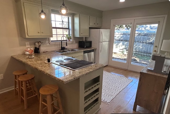 kitchen with double doors to fenced backyard - 7008 Copper Cove