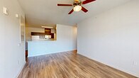 Located in Stonecrest, GA, this single-floor home offers four bedrooms, two bathrooms, a kitchen and living area, a utility room, and a closet. The open-concept kitchen and living space features warm wood-look flooring throughout, complemented by a central kitchen island with dark espresso cabinetry, white appliances including a refrigerator, stove, and dishwasher, and ample upper cabinet storage. The living area is bright and airy, with a ceiling fan, large windows, and a glass-paned door that invites natural light and outdoor views. The four bedrooms are carpeted for comfort, each featuring clean white walls and generous closet space — some with double-door closets. The spacious primary bedroom includes an en suite bathroom outfitted with a wide vanity, dark wood cabinetry, a white quartz countertop, a large wall mirror, and chrome fixtures. The second bathroom features a full tub-shower combination with clean white surrounds. A dedicated utility room adds functional convenience to this well-appointed home. Throughout, the design maintains a clean, modern aesthetic with neutral tones, creating a versatile and move-in-ready living environment.