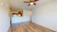 Located in Stonecrest, GA, this single-floor home offers four bedrooms, two bathrooms, a kitchen and living area, a utility room, and a closet. The open-concept kitchen and living space features warm wood-look flooring throughout, complemented by a central kitchen island with dark espresso cabinetry, white appliances including a refrigerator, stove, and dishwasher, and ample upper cabinet storage. The living area is bright and airy, with a ceiling fan, large windows, and a glass-paned door that invites natural light and outdoor views. The four bedrooms are carpeted for comfort, each featuring clean white walls and generous closet space — some with double-door closets. The spacious primary bedroom includes an en suite bathroom outfitted with a wide vanity, dark wood cabinetry, a white quartz countertop, a large wall mirror, and chrome fixtures. The second bathroom features a full tub-shower combination with clean white surrounds. A dedicated utility room adds functional convenience to this well-appointed home. Throughout, the design maintains a clean, modern aesthetic with neutral tones, creating a versatile and move-in-ready living environment.