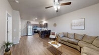 Located at 1441 E Omaha St in Broken Arrow, Oklahoma, this well-designed 2-bedroom, 1-bathroom single-story residence offers a smart and functional layout. The open-concept living, dining, and kitchen area forms the heart of the home, unified by warm wood-look luxury vinyl plank flooring and neutral-toned walls that create a bright, cohesive atmosphere. Ceiling fans provide comfort throughout the main living spaces.

The kitchen is a standout feature, outfitted with rich dark-stained cabinetry, granite-look countertops, a stainless steel refrigerator, range, microwave, and dishwasher. A peninsula with bar seating bridges the kitchen and dining area, making it ideal for casual meals or entertaining. A pantry and dedicated laundry area add practical convenience.

The primary bedroom offers a comfortable retreat with plush carpet flooring and a ceiling fan, while a closet provides ample storage. The full bathroom features a dark wood vanity with a white countertop, a round mirror, stylish light fixture, and wood-look tile flooring. Additional storage is provided by a wall-mounted cabinet.

Completing the layout, the living room benefits from a window that invites natural light, and the entry area provides a welcoming transition into the home. A separate closet and pantry round out the thoughtfully organized floor plan.