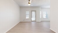 Located at 101 Cimarron Trl in Irving, TX, this single-story, one-bedroom, one-bathroom home offers a well-organized and efficient layout. Light wood-look flooring runs throughout the living areas and bedroom, creating a clean, cohesive aesthetic complemented by crisp white walls and textured ceilings.

The combined kitchen and living room serves as the heart of the home. The living area is bright and open, benefiting from multiple windows with blinds that invite natural light, and is equipped with a ceiling fan. The kitchen stands out with white upper cabinetry, navy lower cabinets, a light quartz countertop, a stainless steel undermount sink, and a full suite of stainless steel appliances including a refrigerator, electric range, and microwave.

The spacious primary bedroom includes a ceiling fan, a window for natural light, and direct access to a dedicated closet. The full bathroom features a tub/shower combination, a toilet, and overhead cabinetry offering practical storage.

An attached garage with an automatic opener provides secure parking and convenient interior access, rounding out the functional offerings of this neatly appointed Irving home.