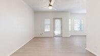 Located at 101 Cimarron Trl in Irving, TX, this single-story, one-bedroom, one-bathroom home offers a well-organized and efficient layout. Light wood-look flooring runs throughout the living areas and bedroom, creating a clean, cohesive aesthetic complemented by crisp white walls and textured ceilings.

The combined kitchen and living room serves as the heart of the home. The living area is bright and open, benefiting from multiple windows with blinds that invite natural light, and is equipped with a ceiling fan. The kitchen stands out with white upper cabinetry, navy lower cabinets, a light quartz countertop, a stainless steel undermount sink, and a full suite of stainless steel appliances including a refrigerator, electric range, and microwave.

The spacious primary bedroom includes a ceiling fan, a window for natural light, and direct access to a dedicated closet. The full bathroom features a tub/shower combination, a toilet, and overhead cabinetry offering practical storage.

An attached garage with an automatic opener provides secure parking and convenient interior access, rounding out the functional offerings of this neatly appointed Irving home.