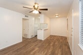 Located at 4314 16th St in Lubbock, Texas, this single-story unit offers a clean, functional layout designed for comfortable everyday living. The open living and dining area is finished with warm wood-look flooring that extends throughout the main areas, complemented by ceiling fans that provide efficient air circulation. A window allows natural light to brighten the living space, creating an inviting atmosphere.

The galley-style kitchen features white cabinetry that extends to the ceiling for ample storage, a white refrigerator, and a peninsula countertop that separates the kitchen from the living area. The layout promotes an efficient workflow while maintaining a connection to the adjoining living space.

The bedroom is carpeted for added warmth and comfort, fitted with its own ceiling fan and a window that brings in natural light. A door provides direct access to the rest of the unit, ensuring easy flow throughout the floor plan.

The bathroom is well-appointed with tile flooring, a vanity with a single-basin sink, a framed mirror, and a tub and shower combination enclosed with full earth-toned tile surround. The crisp white walls throughout the unit contribute to a bright, clean aesthetic. Overall, the space presents a straightforward and practical design well-suited for Lubbock living.