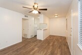 Located at 4314 16th St in Lubbock, Texas, this single-story unit offers a clean, functional layout designed for comfortable everyday living. The open living and dining area is finished with warm wood-look flooring that extends throughout the main areas, complemented by ceiling fans that provide efficient air circulation. A window allows natural light to brighten the living space, creating an inviting atmosphere.

The galley-style kitchen features white cabinetry that extends to the ceiling for ample storage, a white refrigerator, and a peninsula countertop that separates the kitchen from the living area. The layout promotes an efficient workflow while maintaining a connection to the adjoining living space.

The bedroom is carpeted for added warmth and comfort, fitted with its own ceiling fan and a window that brings in natural light. A door provides direct access to the rest of the unit, ensuring easy flow throughout the floor plan.

The bathroom is well-appointed with tile flooring, a vanity with a single-basin sink, a framed mirror, and a tub and shower combination enclosed with full earth-toned tile surround. The crisp white walls throughout the unit contribute to a bright, clean aesthetic. Overall, the space presents a straightforward and practical design well-suited for Lubbock living.