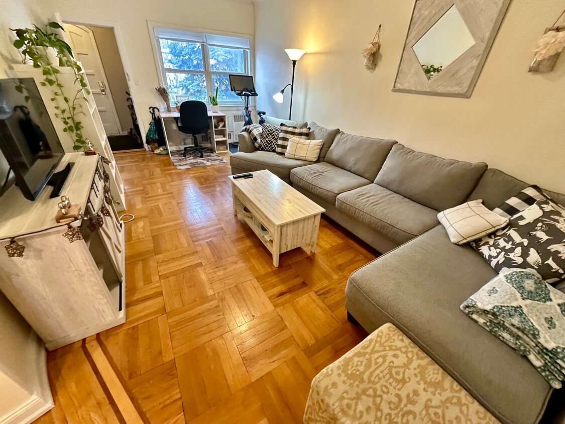 Big Living Room with lovely archway moldings and handsome wood floors. - 16 Micieli Pl