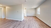Located at 464 Spencerport Rd in Rochester, NY, this one-bedroom, one-bathroom unit offers a well-organized single-floor layout designed for comfortable, everyday living. The open-concept living and dining area is finished with durable light-toned luxury vinyl plank flooring, neutral gray-white walls, and a textured ceiling, creating a clean and airy atmosphere. Large windows allow natural light to fill the space and provide views of the surrounding neighborhood. Baseboard heating is present throughout the main living areas. The galley-style kitchen is outfitted with white shaker cabinetry, a full suite of stainless steel appliances including a refrigerator, stove, microwave, and dishwasher, and matching light vinyl plank flooring, offering a functional and modern workspace. The bedroom provides a comfortable retreat, featuring plush wall-to-wall carpet, a closet, and a window that invites natural light. The full bathroom is bright and well-appointed, featuring a white vanity with storage, wood-look vinyl flooring, a tub-shower combination, and a window for natural ventilation. The unit's consistent neutral palette and updated finishes throughout create a cohesive, move-in-ready living environment.