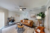 Located at 7250 W Greens Rd in Houston, TX, this thoughtfully designed one-bedroom, one-bathroom unit offers a comfortable and functional layout across a single floor. The open-concept living room serves as the heart of the home, featuring crown molding, dark wood-style flooring, a ceiling fan, and a charming white-mantled fireplace that anchors the space. Natural light filters through sheer curtains, creating a warm and inviting ambiance ideal for both relaxing and working from home.

The kitchen is efficiently laid out with warm honey-toned cabinetry, granite-style countertops, and black appliances including a range, microwave, refrigerator, and dishwasher. Light wood-style flooring and recessed lighting give the kitchen a clean, practical feel.

The generously sized primary bedroom features a ceiling fan, large windows dressed with sheer curtains that invite natural light, and dark hardwood-style flooring, creating a serene retreat. A dedicated closet provides ample storage.

The bathroom includes a single-sink vanity with warm wood cabinetry and a full tub-shower combination. Throughout the unit, neutral gray tones and consistent flooring create a cohesive, modern aesthetic well-suited for everyday living.