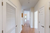 Located at 388 Wade Rd SE in Huntsville, Alabama, this single-story home offers a well-organized layout across three bedrooms and two bathrooms. Light-toned walls and warm wood-look laminate flooring flow throughout much of the home, creating a cohesive and welcoming atmosphere.

The combined dining, kitchen, and living area forms the heart of the home. The kitchen features warm honey-toned cabinetry, a white range, and a pass-through window accented by pendant lighting, opening directly to the dining and living space for easy interaction. This open connection makes the shared living areas feel airy and functional.

A central hallway connects the bedrooms and bathrooms, with a louvered closet door providing convenient storage access near the entry. The bedrooms include a spacious primary suite with ample room, while the additional bedrooms feature the same wood-look flooring and neutral walls, with one room featuring plush carpeting and a ceiling fan. A generously sized walk-in closet with wire shelving serves one of the bedrooms.

Both bathrooms are clean and functional, with one featuring warm wood-toned cabinetry, a single-basin vanity with a large mirror, tile flooring, and brushed nickel hardware. The overall design is straightforward and move-in ready, offering comfortable single-floor living in a convenient Huntsville location.