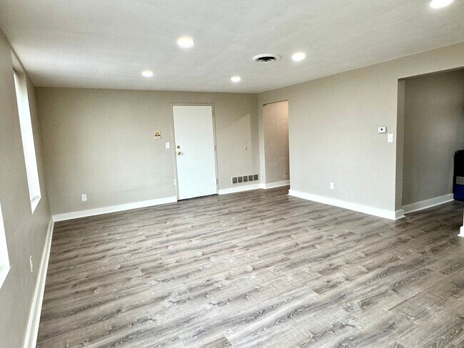 Large living area with luxury vinyl plank flooring. - 7100 Thomas Blvd