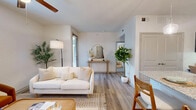 Located at 4900 Windhaven Pkwy in Lewisville, TX, this thoughtfully designed one-bedroom, two-bathroom residence offers a comfortable and functional single-floor layout. The living room sets a welcoming tone with wood-look flooring, a ceiling fan with lighting, and bright windows that invite natural light and views of surrounding greenery. The open-concept kitchen is a standout feature, showcasing dark cabinetry contrasted by granite countertops, stainless steel appliances — including a refrigerator, range, and microwave — and a breakfast bar peninsula ideal for casual dining. A built-in desk nook adjacent to the kitchen provides a dedicated workspace, adding practical versatility to the layout. The bedroom is a calm retreat, featuring plush carpeting, a ceiling fan, and a window with outdoor views, creating a serene atmosphere. Both bathrooms are well-appointed, with one featuring dark wood cabinetry, granite countertops, and modern globe lighting above a large vanity mirror. A dedicated closet provides additional storage. Clean white walls, consistent wood-look flooring in main areas, and neutral tones throughout lend the space a cohesive, modern aesthetic suited for everyday living.