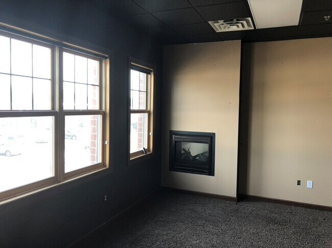 one bedroom with fireplace and bright windows - 20721 Holyoke Ave