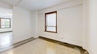 Located at 835 Van Buren in Fort Wayne, Indiana, this one-bedroom, one-bathroom unit offers a well-organized, single-floor layout that makes efficient use of its space. A distinctive terrazzo floor runs throughout, lending a durable and visually striking character to every room.

The kitchen is a standout feature, designed with a clean, modern aesthetic. White shaker-style cabinetry extends along the full length of the wall, complemented by light countertops and a suite of stainless steel appliances including a range, over-the-range microwave, dishwasher, and refrigerator. Natural light enters through a wood-trimmed window, brightening the space.

The hallways connect the living areas fluidly, with one leading to a dedicated closet offering built-in shelving for organized storage. The bedroom is a comfortable, private retreat with its own window dressed in blinds and the same terrazzo flooring found throughout.

The bathroom is finished with elegant marble-style tile surrounding a full soaking tub with a showerhead, paired with a white vanity and terrazzo floors that tie cohesively to the rest of the unit. Recessed lighting and a ceiling vent complete the clean, functional design. Throughout the unit, white walls and natural light contribute to a bright, neutral ambiance.