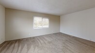 Located at 5555 E Evergreen Blvd in Vancouver, Washington, this 2-bedroom, 3-bathroom single-floor residence offers a well-organized layout designed for comfortable everyday living. The combined kitchen and living room area forms the heart of the home, with the galley-style kitchen featuring white cabinetry, dark laminate countertops, tile flooring, a double sink, electric cooktop, oven, dishwasher, and a dedicated pantry with open shelving for generous storage. The living area is carpeted and finished with neutral tones, providing a clean and versatile backdrop. Both bedrooms are carpeted and filled with natural light through sliding-blind windows that offer views of surrounding greenery. The spacious primary bedroom includes a built-in sliding-door closet, while additional closets throughout the unit provide ample storage. Three bathrooms serve the residence, each featuring tile flooring, vanities with under-sink storage, framed mirrors, and well-maintained fixtures. At least one bathroom includes a tub-shower combination with white tile surround. Textured ceilings and crisp white walls are consistent throughout, lending the space a clean, neutral aesthetic. The unit includes three closets in total, maximizing organizational options across the floor plan.