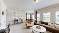Located at 8800 N Ames Dr in Kansas City, MO, this single-floor, one-bedroom, one-bathroom residence offers a thoughtfully designed layout across a comfortable footprint. The open-concept living and dining area is filled with natural light from a bank of large windows dressed with elegant drapes, creating a bright and welcoming atmosphere. The living room features plush carpeting and ample space for seating and entertainment. The adjacent dining area accommodates a round dining table and benefits from its own window, adding to the airy feel of the shared space. The kitchen is well-equipped with rich dark-toned shaker cabinetry, white quartz countertops, a white subway tile backsplash, stainless steel appliances, and light hardwood-style flooring — offering both style and functionality. The generously sized primary bedroom includes plush carpet, vaulted-style ceilings, a ceiling fan, and a dedicated closet. The full bathroom features tile flooring, a tub-shower combination, and dark wood cabinetry for storage. Two hallways connect the spaces efficiently, and the overall neutral palette of warm whites and beiges lends the residence a cohesive, modern aesthetic throughout.
