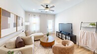 Located at 2076 Legacy Park Trail in Burlington, NC, this thoughtfully designed 2-bedroom, 2-bathroom home offers a comfortable and modern living experience across a single floor. Light wood-style flooring flows throughout the space, complemented by a clean, neutral color palette that creates a bright and welcoming ambiance.

The living room serves as the heart of the home, featuring a ceiling fan, recessed lighting, and natural light from windows and a glass-panel door. The kitchen is well-equipped with taupe cabinetry, white quartz countertops, a subway tile backsplash, and stainless steel appliances, including a range with microwave above. A cozy dining area with a glass-top table sits adjacent to the kitchen alongside a generous closet.

Both bedrooms are comfortably sized, each featuring ceiling fans, light wood flooring, and windows dressed with sheer curtains that allow natural light to filter in. The primary bedroom is a restful retreat with ample space and easy access to the hallway.

The two bathrooms maintain the home's clean aesthetic. The full bathroom includes a single-vanity with light wood cabinetry, white countertops, and a tub-shower combination. A second bathroom offers additional convenience. Together, these spaces make for a practical, move-in-ready home with a cohesive modern design.