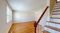 Located at 1160 Whitney Ave in Hamden, CT, this 2-bedroom, 1-bathroom residence spans three floors, offering a well-organized layout with distinct living areas across each level. The main living floor features gleaming hardwood floors that flow throughout the living room and into the bedrooms. The living room is bright and open, fitted with a ceiling fan and easy access to the kitchen. The kitchen is equipped with white cabinetry, a decorative tin backsplash, tile flooring, and ample counter space, lending a clean and functional design. Both bedrooms continue the warm hardwood flooring theme, each featuring windows that allow natural light to fill the rooms. The primary bedroom is generously sized and includes a ceiling fan, while the second bedroom offers a cozy, well-lit space with its own window. The full bathroom showcases classic black-and-white mosaic tile flooring, white square wall tiles accented with a black tile border, a large window for natural light, and a wide vanity with mirror. The lower level provides additional utility space with a painted concrete floor, exposed structural elements, and staircase access, offering practical storage or mechanicals space. Clean, neutral tones and consistent hardwood flooring throughout give this home a cohesive, inviting character.