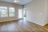 This contemporary 690 square foot apartment offers a thoughtfully designed living space with one bedroom and two full bathrooms. The open-concept layout seamlessly integrates the kitchen, living, and dining areas, creating a spacious feel. The kitchen boasts sleek white cabinetry, stainless steel appliances, and a convenient island, perfect for meal preparation or casual dining.

The primary bedroom, measuring 150 square feet, provides a comfortable retreat with large windows allowing natural light to flood the space. Both bathrooms feature modern fixtures, including vanities with ample storage and stylish finishes. The apartment's closet space is optimized with built-in shelving systems.

Throughout the home, wood-look flooring adds warmth and durability. Large windows in the living area and bedroom not only brighten the space but also offer views of the surrounding area. Ceiling fans provide additional comfort and air circulation.

Located at 7900 Ascend Dr in Kissimmee, Florida, this single-story apartment combines functionality with contemporary design, making it an ideal living space for those seeking modern amenities in a compact, well-organized layout.