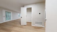 Located at 603 Turnberry Dr in Bloomington, IL, this single-floor, 2-bedroom, 1-bathroom home offers a clean, modern aesthetic with a cohesive neutral color palette throughout. Light-toned luxury vinyl plank flooring runs seamlessly through the main living areas and bedrooms, creating a bright and airy feel.

The open kitchen and living room area serves as the heart of the home. The kitchen is outfitted with white shaker-style cabinetry, light stone-look countertops, and stainless steel appliances including a Samsung range, over-the-range microwave, and refrigerator. The adjacent living area benefits from natural light through windows and direct access via an exterior door.

Both bedrooms are well-proportioned with neutral gray walls, LVP flooring, and large windows that invite natural light and outdoor views. The primary bedroom includes a dedicated closet with built-in wire shelving and hanging rods, along with a smart thermostat for comfort control.

The full bathroom features a clean, minimalist design with light flooring and white fixtures. A dedicated laundry room with a full-size washer and dryer adds everyday convenience. This well-maintained home delivers functional, move-in-ready living in a straightforward, modern package.