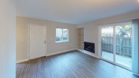 Located at 8842 Winding Way in Fair Oaks, California, this single-floor home offers a clean, modern aesthetic with updated finishes and a practical layout. The living room serves as the heart of the home, featuring wood-look plank flooring, a classic fireplace flanked by built-in shelving, and a sliding glass door that opens to a private outdoor patio, allowing natural light to fill the space. A front-facing window further brightens the room and provides views of the surrounding greenery.

The kitchen is well-appointed with rich dark wood cabinetry, light countertops, and a full suite of stainless steel appliances including a refrigerator, range, and built-in microwave, offering both style and functionality.

The bedrooms are generously sized, each featuring the same wood-look flooring, neutral wall tones, and individual closets for ample storage. One bedroom includes a dedicated walk-in closet and direct access to a private bathroom.

The bathrooms are thoughtfully finished, with one featuring a walk-in shower with a glass enclosure, dark wood vanity, and modern fixtures, while the second offers a full tub-shower combination with equally refined detailing. Clean lines and neutral tones create a cohesive and inviting atmosphere throughout the entire home.