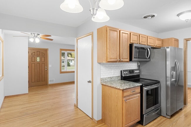 SS appliances, granite countertops, tiled backsplash, ceiling fans & multiple dining options! - 7131 Ewing Ave N