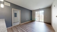 Located in the heart of downtown Columbus at 132 S High St, this 2-bedroom, 2-bathroom residence offers a well-designed open-concept layout with modern finishes throughout. The combined kitchen and living area serves as the centerpiece of the home, featuring rich dark-wood cabinetry, granite countertops, a peninsula with pendant lighting, and a full suite of stainless steel appliances including a range, microwave, and dishwasher. Wood-style flooring runs through the main living areas, adding warmth and continuity to the space. Sliding glass doors open onto a private balcony, framing impressive views of the Columbus skyline and filling the living area with natural light. Both bedrooms are carpeted for comfort, with one offering a generous walk-in closet equipped with wire shelving systems. A hallway connects the bedrooms to two full bathrooms, each finished with dark vanity cabinetry, granite countertops, and a tub-shower combination with white subway tile surround. One bathroom also features built-in open shelving for additional storage. A dedicated laundry area and utility room add practical convenience. Two walk-in closets provide ample storage throughout the residence, rounding out this well-appointed urban home.