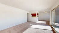 Located at 610 Towne Center Dr in Joppa, MD, this two-bedroom, two-bathroom single-floor residence offers a well-organized layout designed for comfortable everyday living. The open living room is expansive and bright, filled with natural light streaming through large sliding glass doors that lead to a private balcony with outdoor views. Plush carpeting runs throughout the living and bedroom areas, lending a warm, comfortable feel to the space.

The kitchen features warm-toned wood cabinetry, white appliances including a gas range and dishwasher, and tile flooring. A pass-through counter with pendant lighting connects the kitchen to the living area, creating a natural flow ideal for entertaining. An adjacent hallway provides access to an in-unit stacked washer and dryer.

Both bedrooms are generously sized, carpeted, and receive natural light through window blinds. The spacious primary bedroom includes sliding glass door access to the balcony, extending the living space outdoors. Each bathroom is well-appointed with white vanity cabinetry, lighted mirrors, and tile finishes. One bathroom features a glass-enclosed walk-in shower with neutral tile surround. The layout is completed by two hallways and a dedicated closet, providing ample storage throughout.