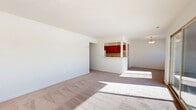 Located at 610 Towne Center Dr in Joppa, MD, this two-bedroom, two-bathroom single-floor residence offers a well-organized layout designed for comfortable everyday living. The open living room is expansive and bright, filled with natural light streaming through large sliding glass doors that lead to a private balcony with outdoor views. Plush carpeting runs throughout the living and bedroom areas, lending a warm, comfortable feel to the space.

The kitchen features warm-toned wood cabinetry, white appliances including a gas range and dishwasher, and tile flooring. A pass-through counter with pendant lighting connects the kitchen to the living area, creating a natural flow ideal for entertaining. An adjacent hallway provides access to an in-unit stacked washer and dryer.

Both bedrooms are generously sized, carpeted, and receive natural light through window blinds. The spacious primary bedroom includes sliding glass door access to the balcony, extending the living space outdoors. Each bathroom is well-appointed with white vanity cabinetry, lighted mirrors, and tile finishes. One bathroom features a glass-enclosed walk-in shower with neutral tile surround. The layout is completed by two hallways and a dedicated closet, providing ample storage throughout.