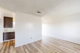 This 480 square foot apartment in Bakersfield, CA offers a thoughtful layout maximizing its compact space. The single-story unit features one bedroom and one bathroom, making it suitable for individuals or couples. The living area showcases modern wood-look flooring, creating a warm and inviting atmosphere. Large windows in the living room and bedroom allow ample natural light, enhancing the sense of space.

The kitchen, while compact, is efficiently designed with ample cabinetry, a double sink, and full-sized appliances. The wood-toned cabinets contrast nicely with the light countertops, maintaining a cohesive look with the flooring. The bathroom features a shower-tub combo with sliding glass doors, offering both practicality and a clean aesthetic.

The bedroom, measuring 120 square feet, includes a sliding closet door for storage. The room is finished with plush carpeting, adding comfort underfoot. Throughout the apartment, white walls and a textured ceiling contribute to a bright, open feel. The property's layout, with its combined kitchen and living area, maximizes the available space, creating a functional and contemporary living environment.