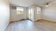 Located at 101 Robson Rd in Leamington, Ontario, this 2-bedroom, 1-bathroom unit offers a practical and comfortable single-floor layout. Light grey vinyl plank flooring runs throughout the home, providing a clean, cohesive look that ties each room together. The living room is a generously sized, open area filled with natural light from multiple windows and a sliding door that leads to a balcony, offering pleasant outdoor views of the surrounding greenery. A ceiling fan adds to the room's comfort, and baseboard heating is present throughout. The kitchen features warm-toned wood cabinetry in a classic U-shaped layout, complete with white appliances including a refrigerator, electric range, and ample overhead cabinet storage. Both bedrooms are well-proportioned, bright spaces with windows overlooking the outdoors and baseboard heating. The primary bedroom includes a built-in closet with a sliding wood-panel door and dedicated hanging storage. The bathroom is finished with full-height marble-style ceramic tile surrounding the tub-shower combination, complemented by matching floor tiles for a polished, cohesive appearance. A dedicated entrance and hallway provide a smooth transition between rooms, completing this functional and neatly finished home.