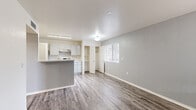 This well-designed 2-bedroom, 1-bathroom single-story home in Santa Teresa, NM offers a practical and comfortable layout. The open-concept living and kitchen area is anchored by a peninsula counter, providing both workspace and a casual dining option. The kitchen is well-appointed with white cabinetry, light stone-look countertops, stainless steel appliances including a range and refrigerator, and a double-basin sink. Wood-look plank flooring runs throughout the main living areas, adding warmth and durability, while a window in the living area brings in natural light.

Both bedrooms feature plush carpet flooring and windows that allow natural light to filter in. The primary bedroom includes a dedicated closet with built-in shelving, while the second bedroom offers a walk-in style closet area. A hallway connects the bedrooms to the shared full bathroom, which includes a tub/shower combination.

A dedicated laundry area with washer and dryer hookups adds everyday convenience. The home also includes a closet for additional storage. Clean neutral tones throughout create a bright, move-in ready feel suited for comfortable everyday living.