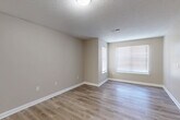 Located at 112 Martin Ln in Gaffney, South Carolina, this single-floor, 2-bedroom, 3-bathroom home offers a clean, functional layout with a neutral color palette throughout. The open living area features light luxury vinyl plank flooring and a textured ceiling, creating a bright and welcoming atmosphere with natural light streaming through large, blinds-fitted windows.

The kitchen is well-appointed with white cabinetry, granite-style countertops, a double stainless steel sink, a dishwasher, and a refrigerator — providing ample storage and counter workspace in a compact, efficient design. The LVP flooring continues seamlessly from the living area into the kitchen.

The primary bedroom is a comfortable, well-sized retreat with plush carpeting and its own private ensuite bathroom. The ensuite features a vanity with white cabinetry, granite-style countertops, a large mirror, and a bathtub, alongside a dedicated walk-in closet with wire shelving. The second bedroom also features carpet flooring, a ceiling fan, a window for natural light, and access to a closet. The bathrooms throughout maintain a consistent, clean aesthetic with light-toned finishes and LVP flooring. A hallway connects the living spaces, contributing to the home's efficient and practical single-floor flow.