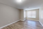 Located at 112 Martin Ln in Gaffney, South Carolina, this single-floor, 2-bedroom, 3-bathroom home offers a clean, functional layout with a neutral color palette throughout. The open living area features light luxury vinyl plank flooring and a textured ceiling, creating a bright and welcoming atmosphere with natural light streaming through large, blinds-fitted windows.

The kitchen is well-appointed with white cabinetry, granite-style countertops, a double stainless steel sink, a dishwasher, and a refrigerator — providing ample storage and counter workspace in a compact, efficient design. The LVP flooring continues seamlessly from the living area into the kitchen.

The primary bedroom is a comfortable, well-sized retreat with plush carpeting and its own private ensuite bathroom. The ensuite features a vanity with white cabinetry, granite-style countertops, a large mirror, and a bathtub, alongside a dedicated walk-in closet with wire shelving. The second bedroom also features carpet flooring, a ceiling fan, a window for natural light, and access to a closet. The bathrooms throughout maintain a consistent, clean aesthetic with light-toned finishes and LVP flooring. A hallway connects the living spaces, contributing to the home's efficient and practical single-floor flow.
