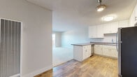 This single-story, 2-bedroom, 1-bathroom residence in Alameda, California, offers a practical and well-organized layout across a comfortable footprint. The open-concept kitchen and living area forms the heart of the home, where hardwood-style flooring extends throughout. The kitchen is equipped with white shaker-style cabinetry providing ample storage, dark countertops, a peninsula with additional prep space, stainless steel appliances including a gas range and refrigerator, and a ceiling-mounted light fixture. The kitchen opens directly into the living area, which features plush carpeting, neutral-toned walls, and a textured ceiling.

Both bedrooms are carpeted and feature sliding mirrored closet doors, offering practical storage solutions. The primary bedroom includes a wide window fitted with horizontal blinds, allowing natural light and neighborhood views. The full bathroom is appointed with a tub-shower combination and chrome fixtures in a clean, white finish. A dedicated closet provides additional storage within the unit. The overall aesthetic is clean and neutral, making it a versatile and functional space located in the heart of Alameda.