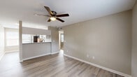 Located at 2360 W Broad St in Athens, GA, this single-floor, 2-bedroom, 1-bathroom home offers a clean, modern aesthetic throughout. The open-concept living room and kitchen area is anchored by light-toned luxury vinyl plank flooring and a ceiling fan with light fixture, creating a bright and comfortable atmosphere. Natural light filters in through windows near the entry door, enhancing the airy feel of the space.

The kitchen is a standout feature, boasting white shaker-style cabinetry with matte black hardware, granite countertops, a stainless steel undermount sink with a black gooseneck faucet, and a full suite of stainless steel appliances including a refrigerator, electric range, over-the-range microwave, and dishwasher. A pass-through counter connects the kitchen to the living area seamlessly.

Both bedrooms are finished with plush carpet and ceiling fans, with the primary bedroom offering a dedicated closet and a window with natural light. Each bedroom includes its own closet for added storage convenience.

The bathroom is neatly finished with granite countertops, white cabinetry, oil-rubbed bronze fixtures, and a full tub-shower combination. A hallway connects all rooms efficiently, completing this thoughtfully laid-out home.