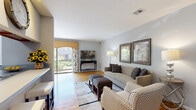 Located at 63 Chapin Rd in Pine Brook, NJ, this two-story, 2-bedroom, 1-bathroom home offers a well-designed layout spread across two floors. The main level opens into a bright, comfortable living room featuring warm hardwood flooring, soft neutral-toned walls, and large windows with access to an outdoor balcony, filling the space with natural light. The living area flows seamlessly into a dedicated dining room, which connects directly to a galley-style kitchen. The kitchen is equipped with stainless steel appliances, rich wood cabinetry, gray countertops, and light tile flooring, offering both functionality and style. The dining area provides an intimate setting with a window overlooking the exterior. The bathroom is tastefully finished with white subway tile wainscoting accented by a gray tile border, a white vanity with modern hardware, and gray floor tile. Upstairs, the spacious primary bedroom features hardwood floors, neutral gray walls, and a window that brings in natural light. The second bedroom is similarly appointed with hardwood flooring and a bright window. A staircase and hallway connect the two levels, completing this efficiently designed and well-appointed home.