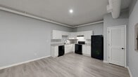 Located at 776 Baconsfield Dr in Macon, GA, this single-floor unit offers 2 bedrooms, 2 bathrooms, 2 closets, and a dedicated utility room within a efficiently organized floor plan. Light gray walls and light-toned luxury vinyl plank flooring run consistently throughout, creating a cohesive, clean aesthetic. The open-concept living and kitchen area forms the heart of the unit, with recessed lighting and exposed HVAC ductwork lending an industrial character to the space. The kitchen is outfitted with white shaker cabinetry accented by gold hardware, granite-look countertops, a stainless steel sink, and a full suite of black appliances including a refrigerator, electric range, dishwasher, and range hood. Both bedrooms are well-proportioned, with the primary bedroom offering a comfortable footprint suited for standard furnishings. One bedroom features a window allowing natural light to fill the room. The two bathrooms are finished in a clean, modern style, with one featuring a walk-in shower, white vanity, and a bold blue countertop as a standout design detail. Additional storage is provided by two dedicated closets, and a utility room adds practical functionality to the layout.