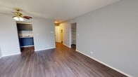 Located at 563 Deere Park Circle in Bartlett, IL, this single-floor unit offers a clean, functional layout with modern updates throughout. The living area is finished with rich, dark hardwood-style flooring, neutral gray walls, and a ceiling fan with a light fixture, creating a bright and airy atmosphere. A window allows natural light to fill the space, while a baseboard heater ensures year-round comfort. Built-in open shelving is integrated into one wall, providing convenient storage and display space.

The kitchen is well-appointed with slate-gray upper and lower cabinetry featuring sleek bar-pull hardware, white tile backsplash, light countertops, a stainless steel double-basin sink, and black appliances including a gas range and a full-sized refrigerator. Hardwood-style flooring continues seamlessly into this space.

The bedroom is carpeted for comfort and includes dual closets with bifold doors and built-in rods, offering generous storage capacity. The full bathroom is neatly finished with a white vanity, a tiled shower-tub combination, and hardwood-style flooring, maintaining a consistent and cohesive aesthetic throughout the unit. A hallway connects all areas, enhancing the overall flow of this well-organized single-level home.