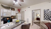 Located at 2010 E Omaha St in Broken Arrow, Oklahoma, this one-bedroom, one-bathroom unit offers a thoughtfully arranged single-floor layout that maximizes every square foot. The living room features soft carpet flooring, a ceiling fan with light fixture, and a window that brings in natural light, creating a comfortable and inviting atmosphere.

The kitchen is well-equipped with white cabinetry, a black electric range, microwave, and a full-size refrigerator. Tile flooring anchors the space, while a peninsula with a dark granite-style countertop doubles as a breakfast bar with seating, seamlessly connecting the kitchen to the main living area.

The bedroom is a calm retreat with plush carpet, a ceiling fan, a window for natural light, and direct access to a dedicated closet with built-in shelving. The full bathroom features tile flooring, a shower-tub combo enclosed by sliding glass doors, and overhead cabinetry for added storage.

A separate laundry area houses a full-size washer and dryer along with wire shelving for additional storage. Ceiling fans are present throughout the unit, contributing to year-round comfort. This compact yet complete layout includes all the essential spaces for comfortable everyday living.