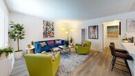 Located at 2301 E Market St in Long Beach, California, this single-floor residence offers a well-organized and thoughtfully designed layout that balances comfort with modern style. The living room serves as the heart of the home, featuring warm wood-style flooring, a textured ceiling, and a large window that welcomes natural light. The space is open and inviting, with ample room for seating and entertaining.

Adjacent to the living area is a dedicated dining nook, illuminated by a sculptural globe chandelier and brightened by a window. The round marble-top table and soft seating make it an intimate setting for meals.

The kitchen is efficiently designed with sage-toned cabinetry, sleek black hardware, white quartz countertops, and a full suite of stainless steel appliances including a gas range, over-the-range microwave, and a side-by-side refrigerator with water and ice dispenser.

The bedroom is a serene retreat, outfitted with a ceiling fan, wood-style flooring, and a sliding glass door that opens directly to a private outdoor patio — ideal for morning coffee or quiet relaxation. The bathroom is clean and functional, featuring a soaking tub with a rainfall showerhead and modern chrome fixtures with a frosted privacy window above.