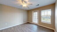 Located at 3540 N Inwood St in Wichita, KS, this well-appointed single-story residence offers a practical and comfortable layout across its one bedroom and one bathroom. The living room greets you with warm, wood-style flooring, neutral beige walls, a ceiling fan with light fixture, and direct access to the outdoors through a glass-paneled door flanked by windows that bring in generous natural light. The open-concept kitchen and living area are connected via a half-wall pass-through, giving the space an airy, connected feel. The kitchen is equipped with warm wood cabinetry, light countertops, a double-basin sink, a dishwasher, and a range, with overhead lighting adding a welcoming ambiance. A dedicated laundry area accommodates a full-size washer and dryer, adding everyday convenience. The bedroom features plush carpeting, a ceiling fan, a large window with exterior views, and dual closet doors providing ample storage. The bathroom includes a wood-toned vanity with storage, a toilet, and a full tub and shower combination, finished with durable wood-style flooring. Throughout the space, neutral tones and functional finishes create a clean, cohesive living environment.