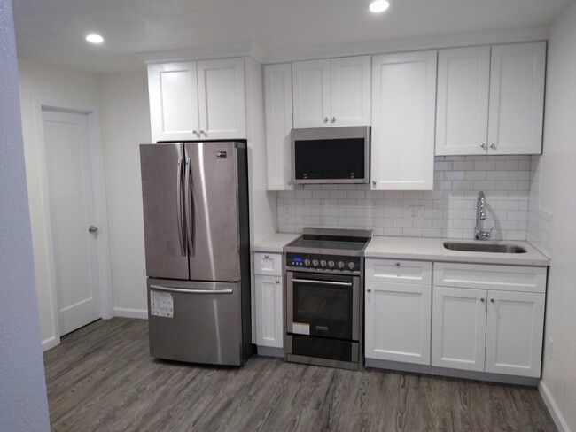 Kitchen is brand new and will include all brand-new stainless-steel top of the line Samsung appliances. Garbage disposal, dishwasher, stove, microwave, and refrigerator. All lights have dimmable switches. Modern color scheme with brand new shaker white cabinets. - 1450 166th Ave