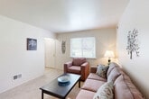 Located in Brownstown, Michigan, this two-story home offers a functional and well-organized layout spread evenly across two floors. The main level features a carpeted living room filled with natural light from a large window with blinds, providing outdoor views of the surrounding greenery. The space is open and comfortable, with neutral-toned walls that create a clean, inviting atmosphere. Adjacent to the living area is a galley-style kitchen finished with warm wood cabinetry, light countertops, tile flooring, a gas range, and a single-basin sink — efficiently designed to maximize every inch of available space. A skylight detail above adds a bright touch to the kitchen. The upper floor houses all three bedrooms, each carpeted and featuring closets with bi-fold doors for ample storage. The primary bedroom is a well-proportioned retreat with its own closet, while the additional bedrooms offer windows with natural light and comfortable dimensions suited for various uses. The single full bathroom is clean and straightforward, featuring a tiled tub-shower combination. Two staircases and two hallways connect the floors and rooms efficiently. With four total closets throughout, storage is thoughtfully distributed across the home.