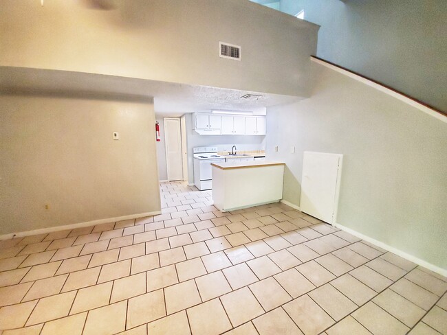 Living area is open to the galley kitchen. Stairs to lead to large loft bedroom. - 28600 Netawake Ct